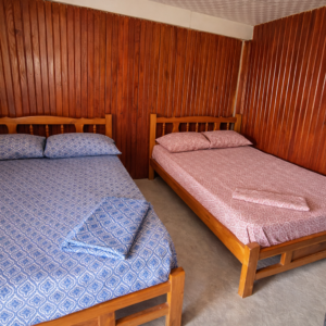 Rustic cabin interior Isla Perro San Blas twin beds near the beach