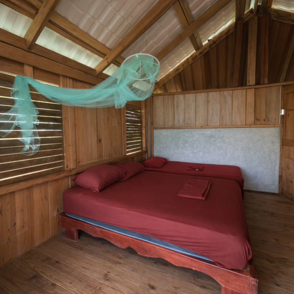 Interior of a private cabin with private bathroom in Isla Aguja San Blas Panama simple tropical island accommodation